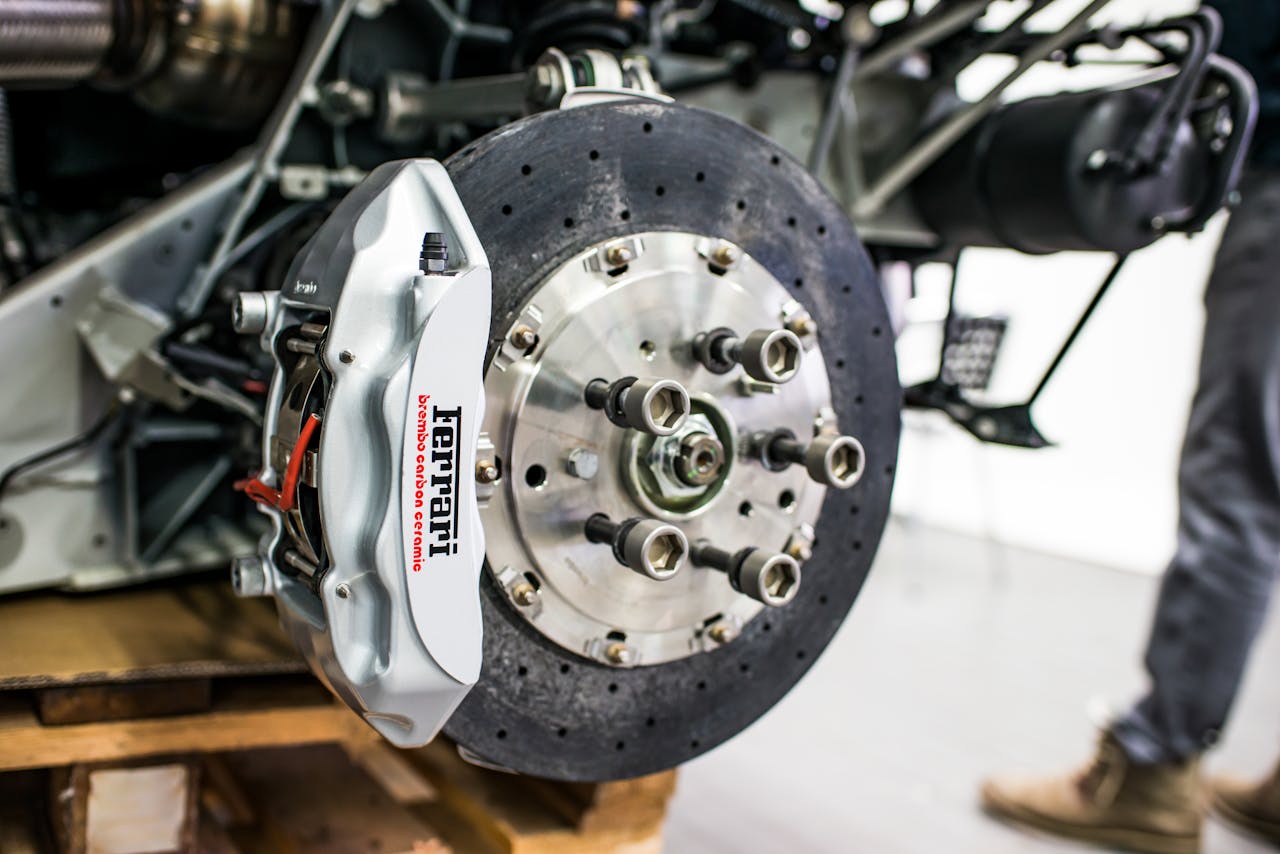 services-01 Detailed view of disc brake and caliper on a high-performance car, emphasizing precision and technology.